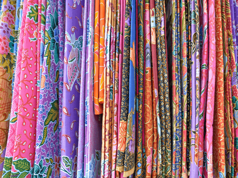 Bali Travel Tips: 5 Do’s And Dont'S To Know 6 Colorful indonesian sarongs with traditional batik patterns displayed in a local market